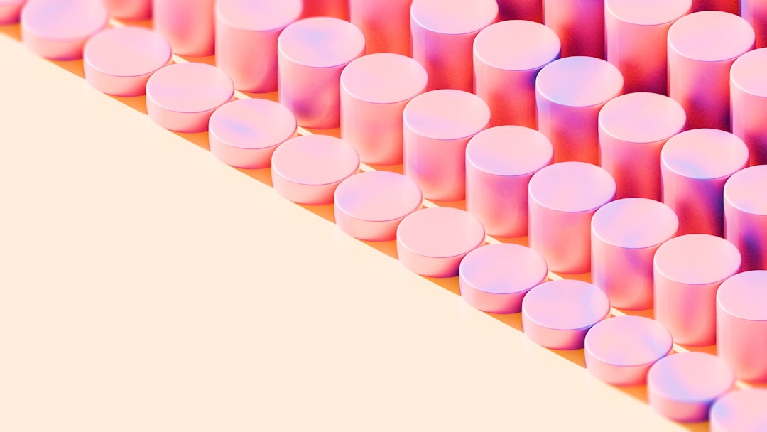 A vibrant and stylish 3D rendering of glossy pastel cylinders arranged in a clean, repeating pattern. Featuring soft pink, peach, and lavender tones, this modern abstract artwork is perfect for minimalist branding, tech-forward web design, editorial layouts, app interfaces, and motion graphics. Its clean geometry and dreamy lighting give it a contemporary, polished aesthetic, great for backgrounds or digital mood boards.